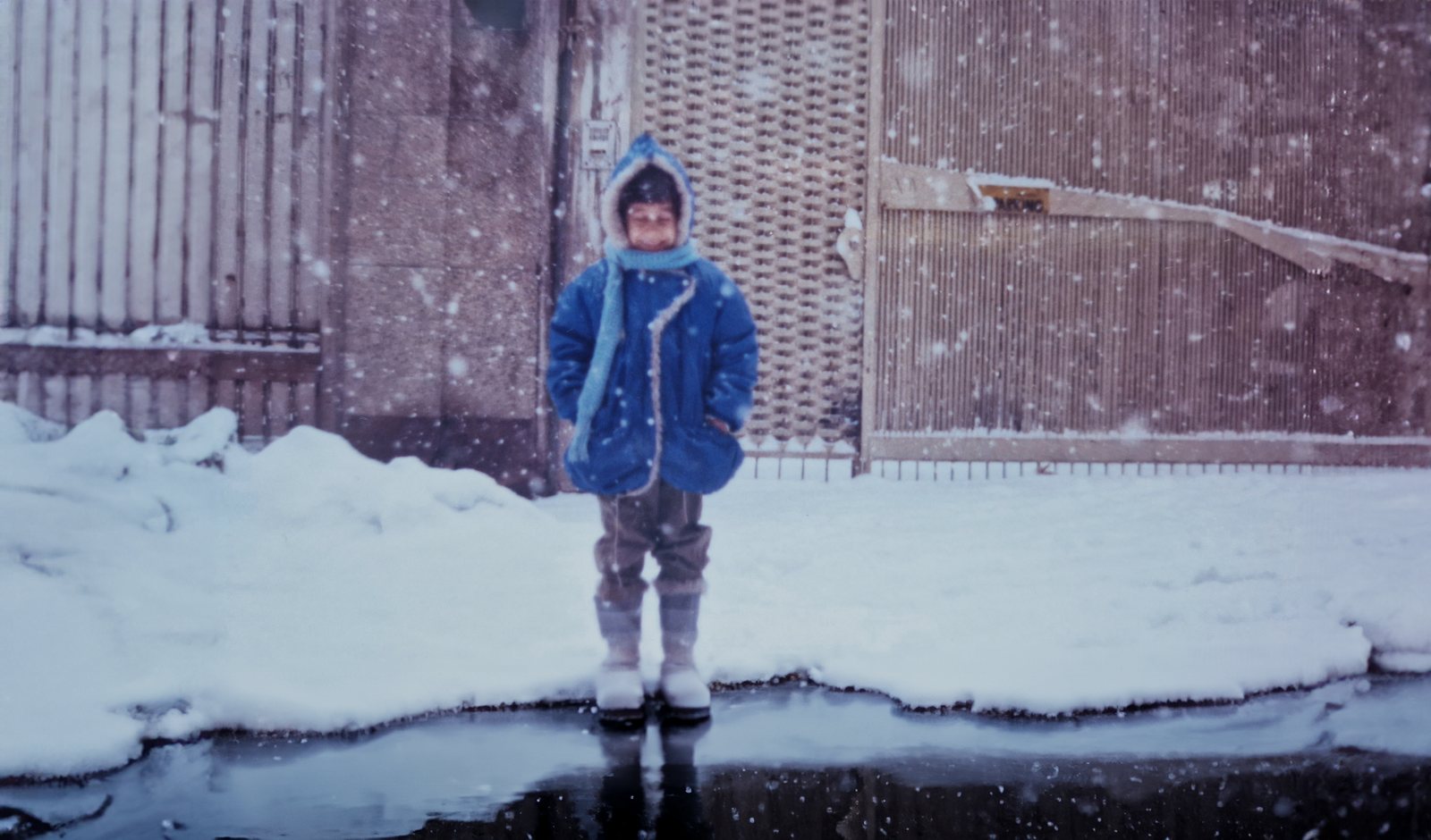 Mani Nickpour as a child, standing in the snow