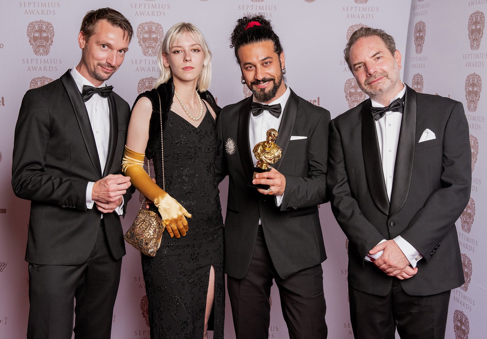 Mani Nickpour holding an award with members of the film crew